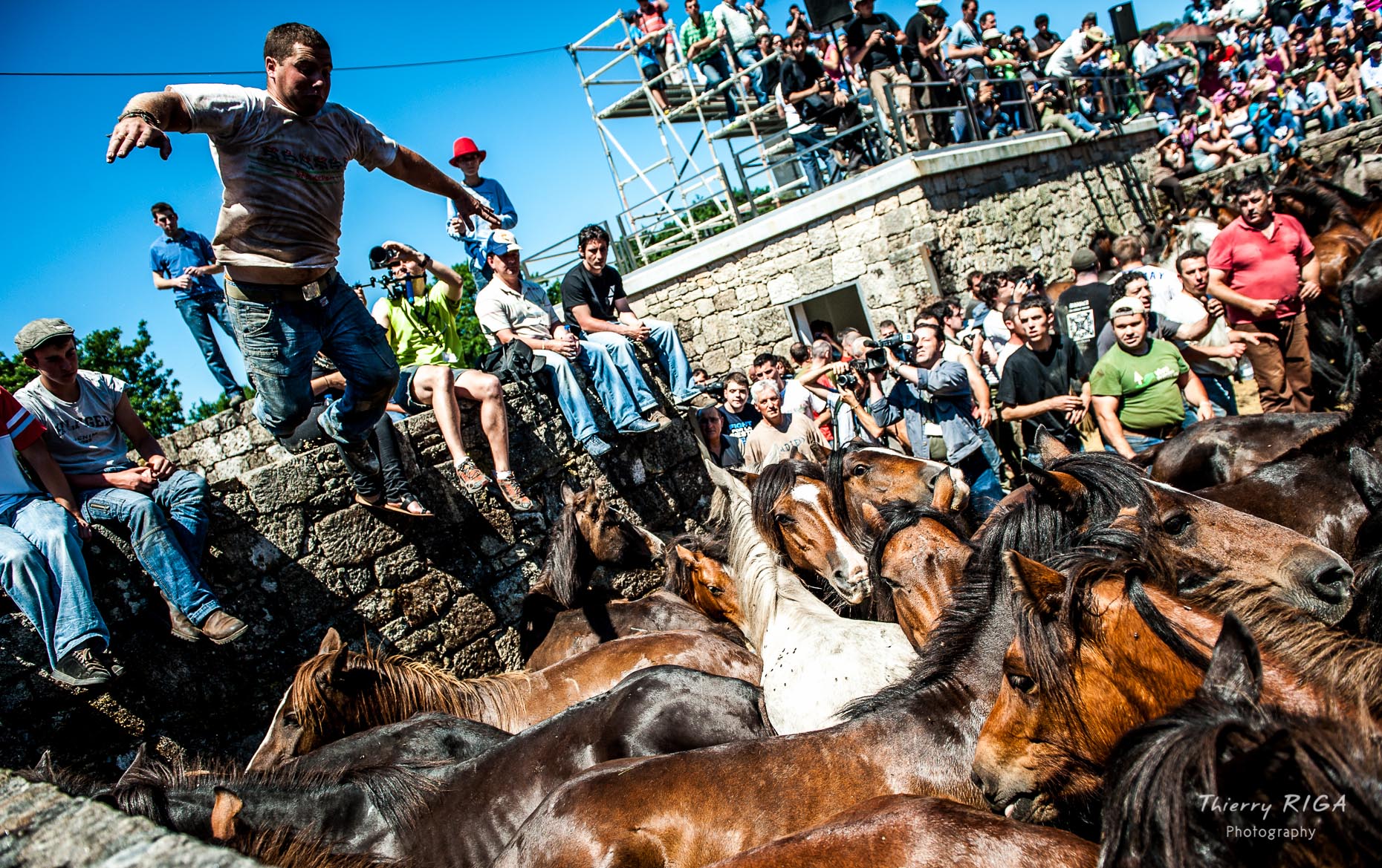 men showing off their jumping skills, Rapa das Bestas, Sabucedo, Spain