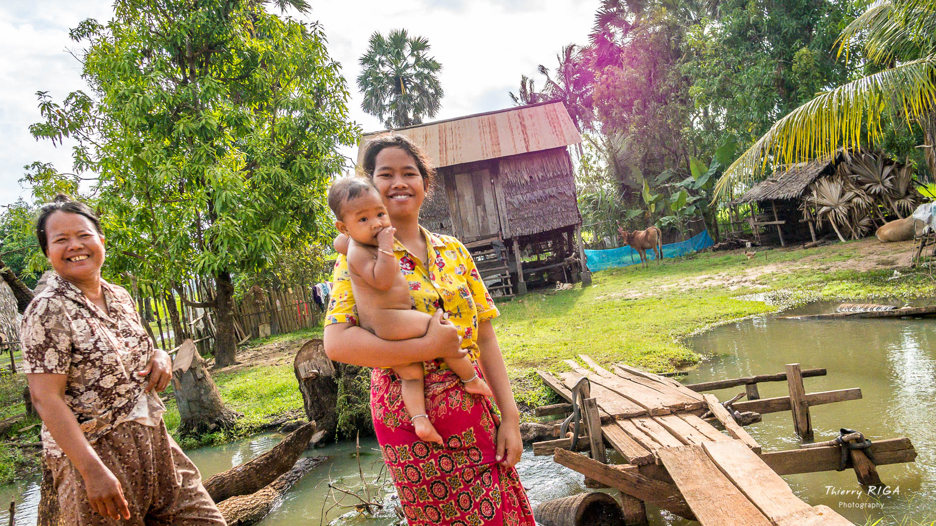 smiling women and baby in cambodian village, Thierry Riga, Angkor Photography