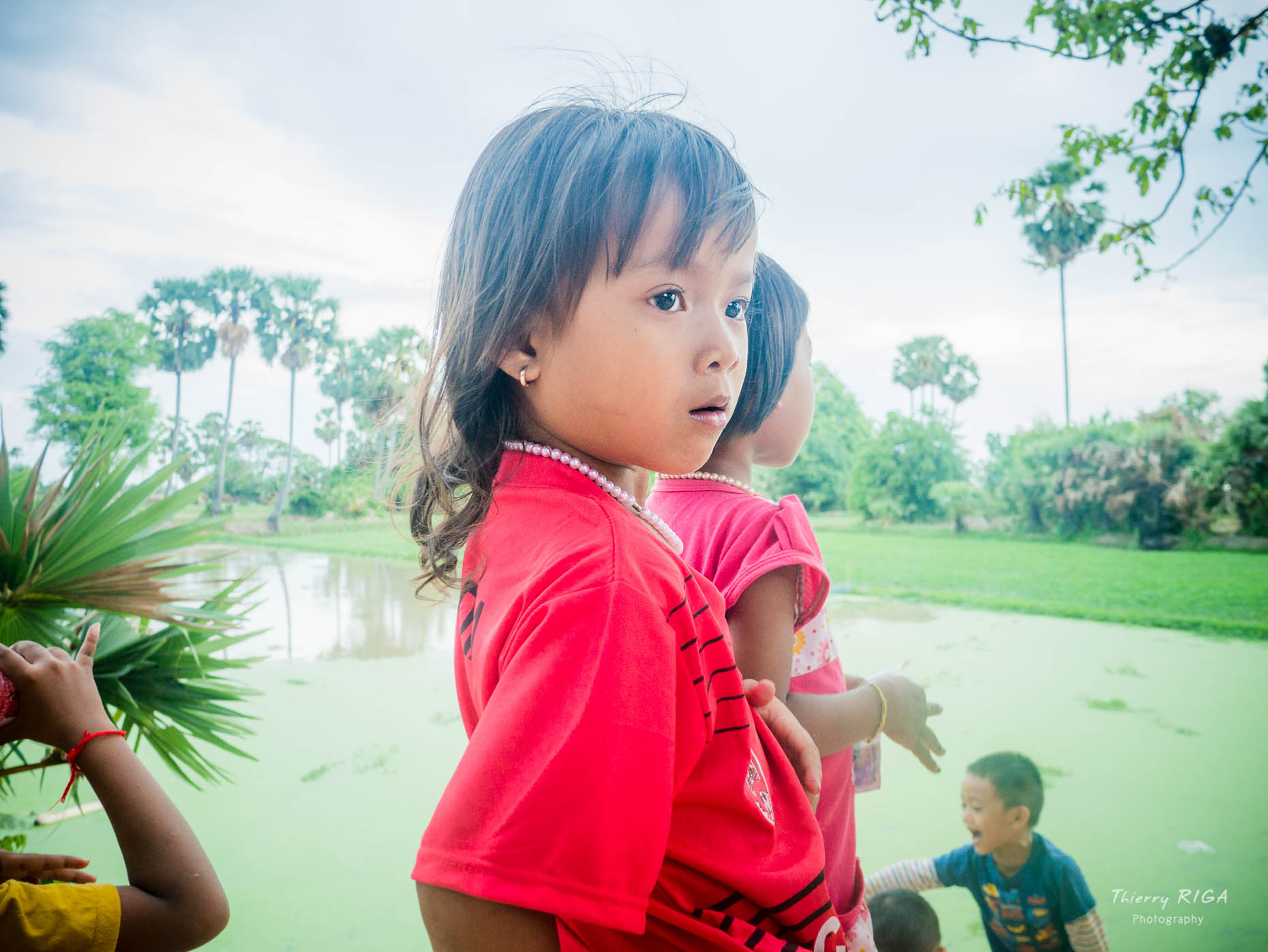 young girl in red in Cambodian countryside, Thierry Riga, Angkor Photography