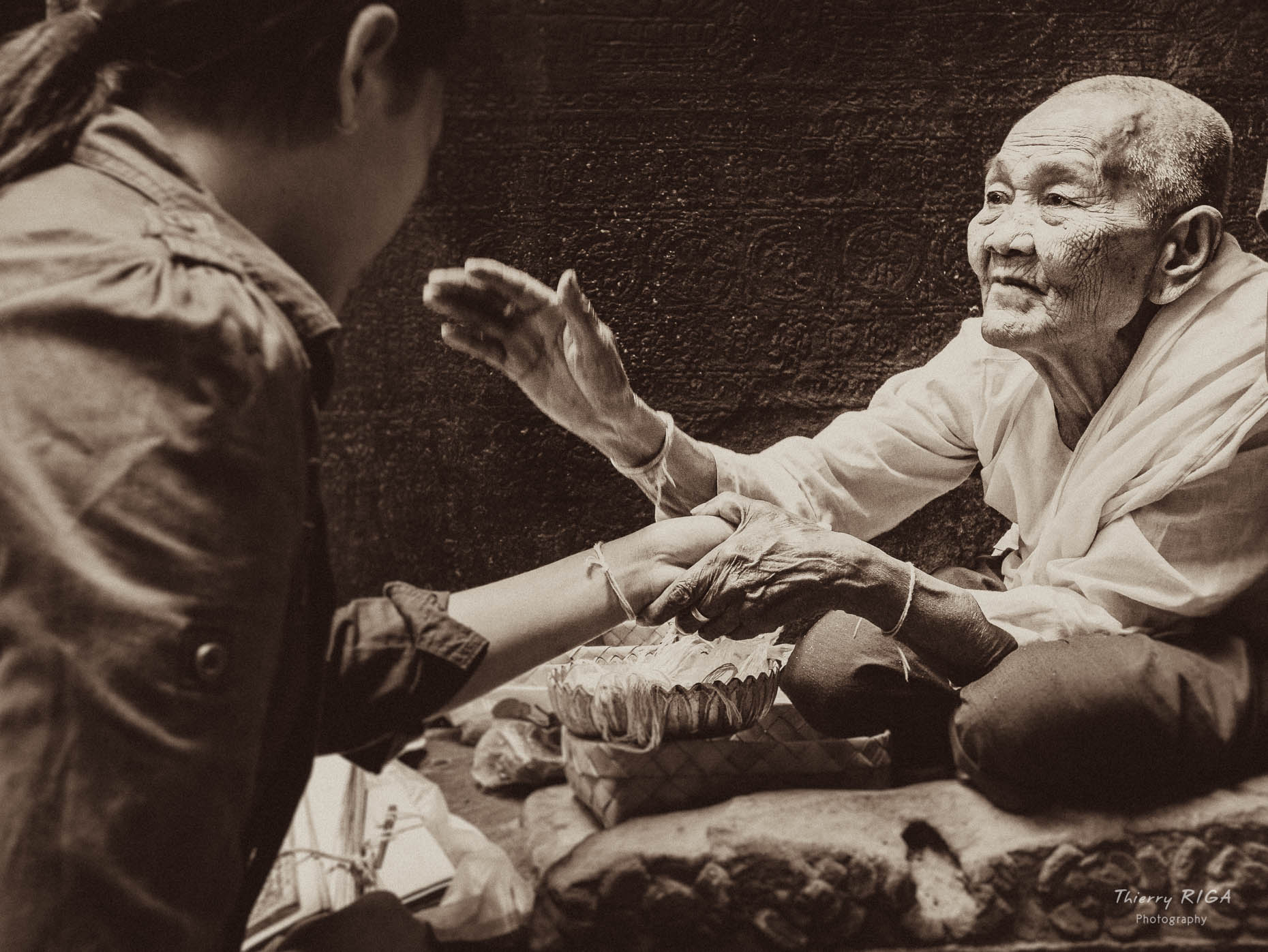 blessing from an old woman in a Temple of Angkor, Thierry Riga, Angkor Photography