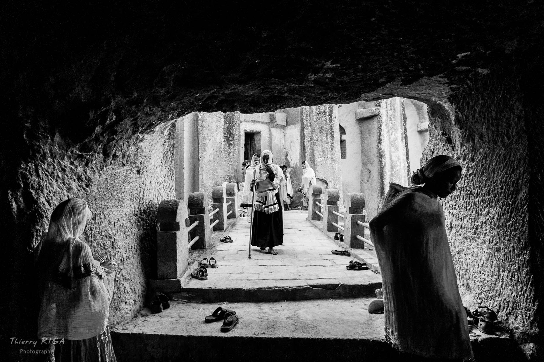 Women prying in an underground bridge in the maze of Gabriel Raphael church in Lalibela, Ethiopia, Thierry Riga