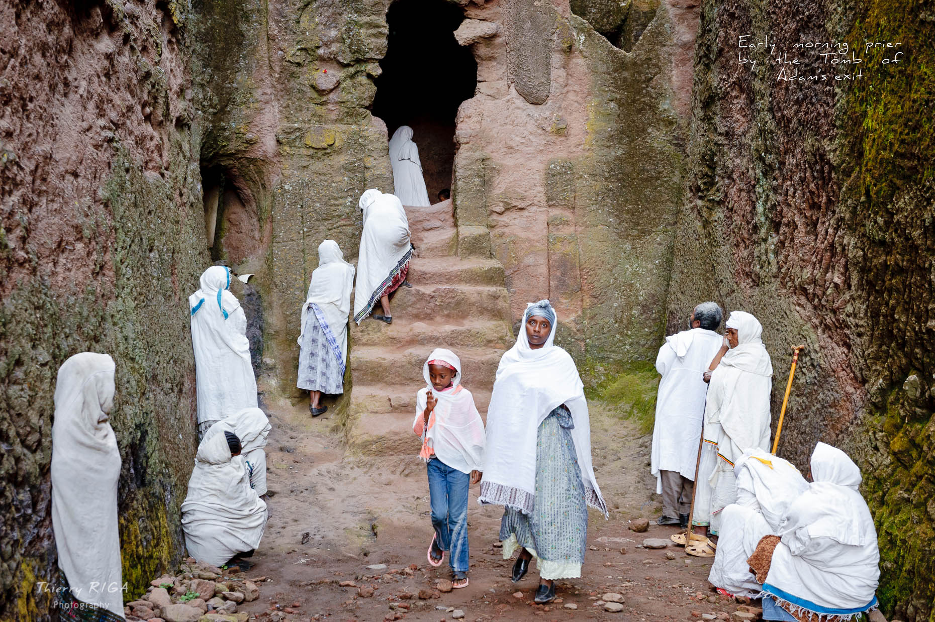 Women in white praying in the maze of the Tomb of Adam in Lalibela, Ethiopia