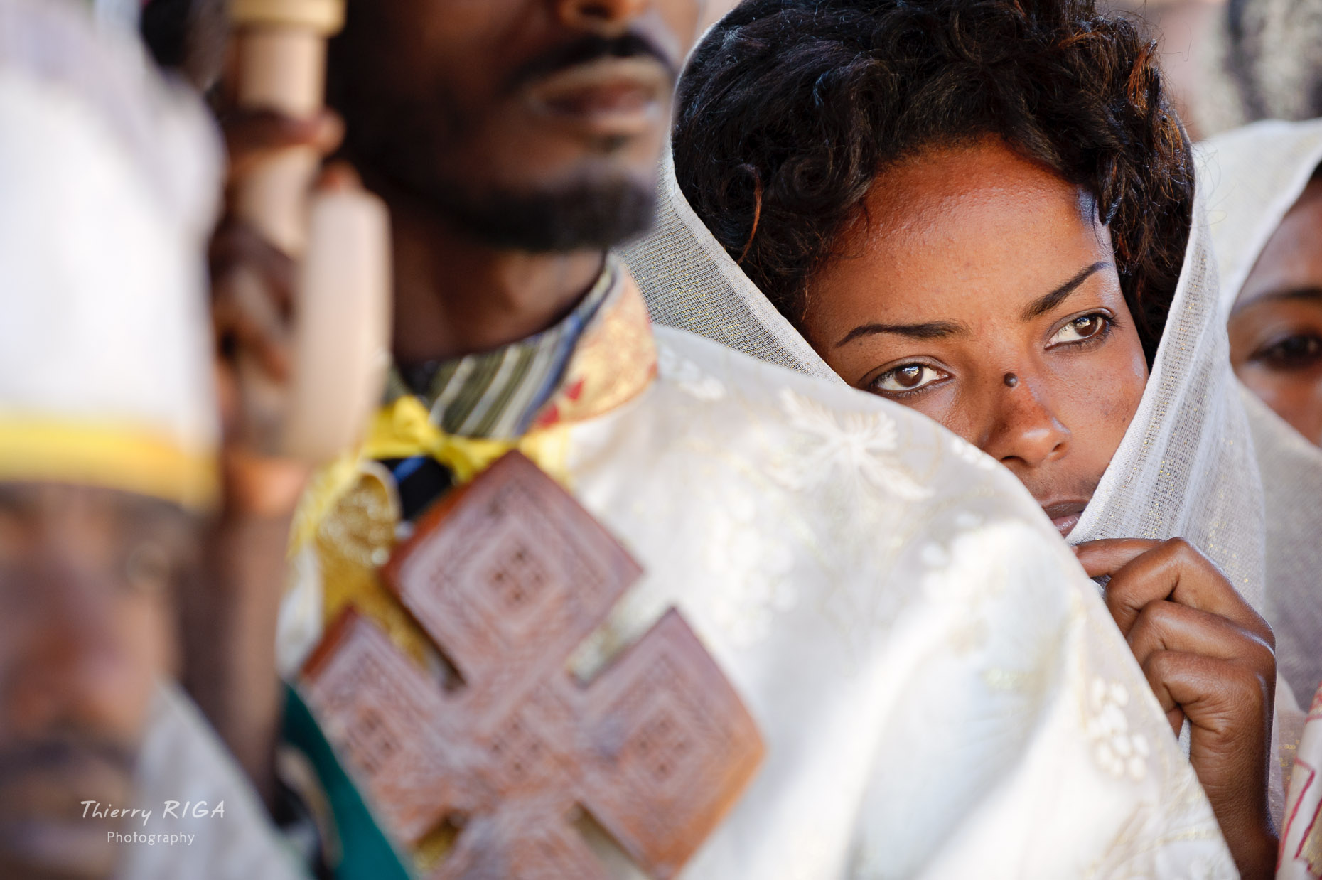 Woman hidden behind a priest, Meskel ceremonies, Lalibela, Ethiopia