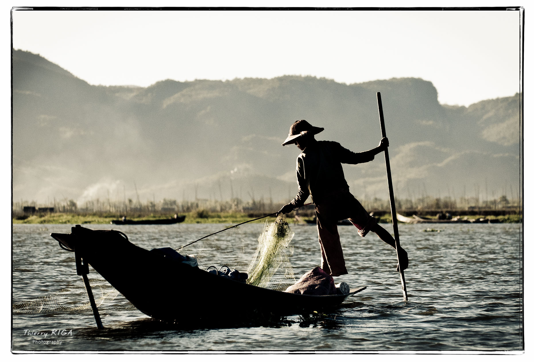 Inlay lake fisherman rowing with his leg, Myanmar